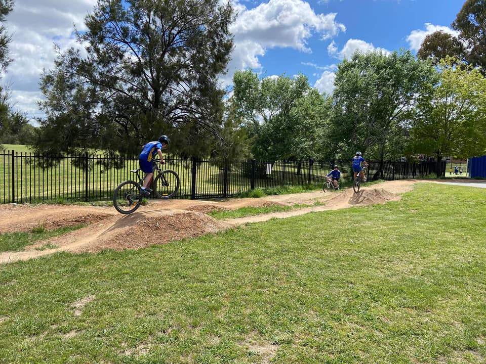 students riding bikes on dirt track