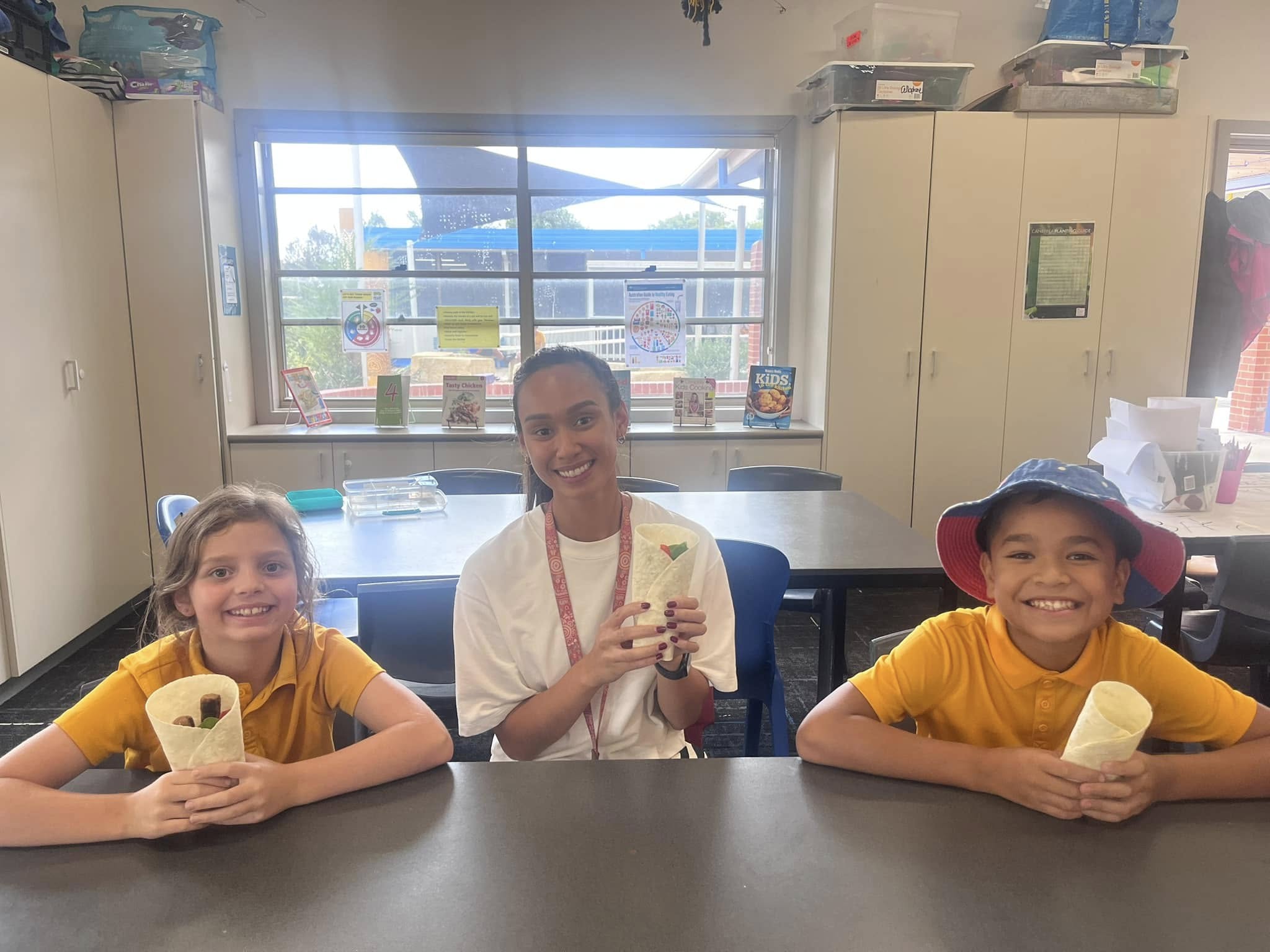 Photo of 2 students and a teacher holding a wrap